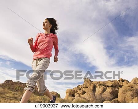 USA, California, Joshua Tree National Park, Young woman jogging in desert View Large Photo Image Stock Photo - USA, California, Joshua Tree National Park, Young woman jogging in desert. Fotosearch