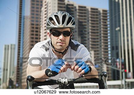 USA, California, Los Angeles, Portrait of young man road cycling on city street View Large Photo Image Stock Photo - USA, California, Los Angeles, Portrait of young man road cycling on city street. Fotosearch