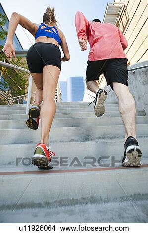 USA, California, Los Angeles, Young man and young woman running on city street View Large Photo Image Picture - USA, California, Los Angeles, Young man and young woman running on city street. Fotosearch