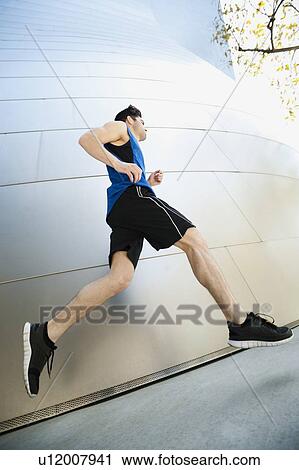 USA, California, Los Angeles, Young man jogging in city View Large Photo Image Stock Image - USA, California, Los Angeles, Young man jogging in city. Fotosearch