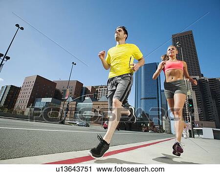 USA, California, Los Angeles, Young man and young woman running on city street View Large Photo Image Stock Image - USA, California, Los Angeles, Young man and young woman running on city street. Fotosearch