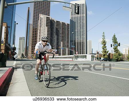 USA, California, Los Angeles, Young man road cycling on city street View Large Photo Image Stock Image - USA, California, Los Angeles, Young man road cycling on city street. Fotosearch