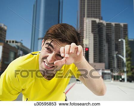 USA, California, Los Angeles, Young man resting after running on city street View Large Photo Image Stock Image - USA, California, Los Angeles, Young man resting after running on city street. Fotosearch