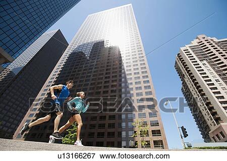 USA, California, Los Angeles, Young man and young woman running in city View Large Photo Image Stock Photo - USA, California, Los Angeles, Young man and young woman running in city. Fotosearch