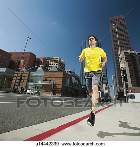 USA, California, Los Angeles, Young man running on city street View Large Photo Image Stock Photo - USA, California, Los Angeles, Young man running on city street. Fotosearch