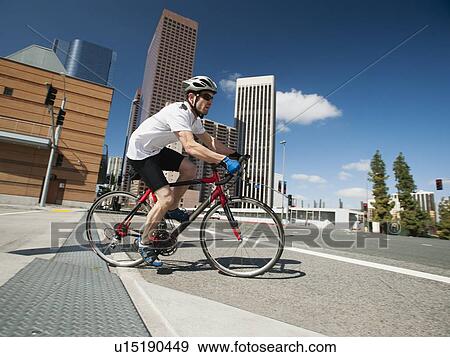 USA, California, Los Angeles, Young man road cycling on city street View Large Photo Image Stock Photo - USA, California, Los Angeles, Young man road cycling on city street. Fotosearch