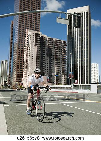 USA, California, Los Angeles, Young man road cycling on city street View Large Photo Image Stock Photo - USA, California, Los Angeles, Young man road cycling on city street. Fotosearch