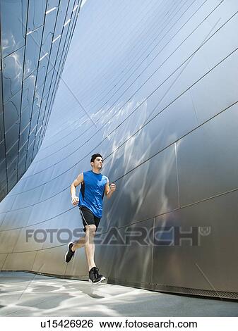 USA, California, Los Angeles, Young man jogging in city View Large Photo Image Stock Photograph - USA, California, Los Angeles, Young man jogging in city. Fotosearch