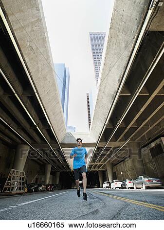 USA, California, Los Angeles, Young man running on city street View Large Photo Image Stock Photography - USA, California, Los Angeles, Young man running on city street. Fotosearch