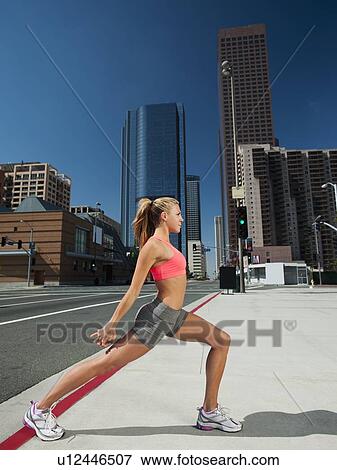 Stock Photo - USA, California, Los Angeles, Young woman exercising on city street. Fotosearch