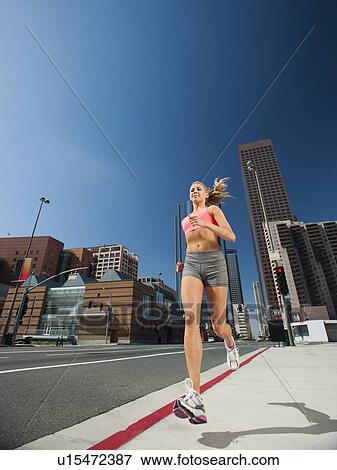 USA, California, Los Angeles, Young woman running on city street View Large Photo Image Stock Photo - USA, California, Los Angeles, Young woman running on city street. Fotosearch