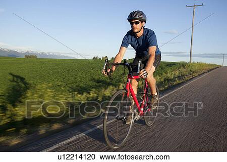 USA, Montana, Kalispell, Cyclist captured in motion View Large Photo Image Stock Image - USA, Montana, Kalispell, Cyclist captured in motion. Fotosearch