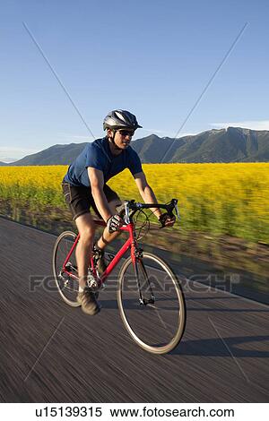 Stock Photography - USA, Montana, Kalispell, Cyclist captured in motion. Fotosearch