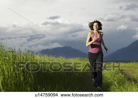 USA, Montana, Whitefish, Woman jogging on mountain path View Large Photo Image Picture - USA, Montana, Whitefish, Woman jogging on mountain path. Fotosearch