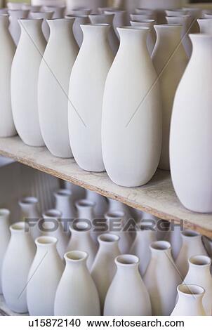 Stock Image - USA, New Jersey, Jersey City, Pottery on shelves. Fotosearch