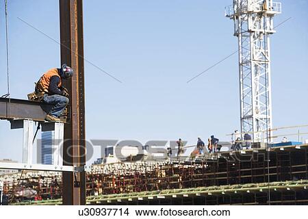 Picture - USA, New York, Long Island, New York City, Male worker on construction site. Fotosearch