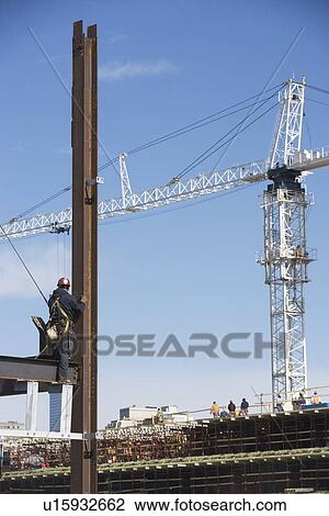Stock Image - USA, New York, Long Island, New York City, Male worker on construction site. Fotosearch