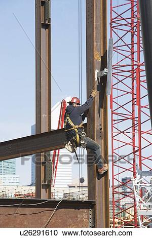 Stock Image - USA, New York, Long Island, New York City, Male worker on construction site. Fotosearch
