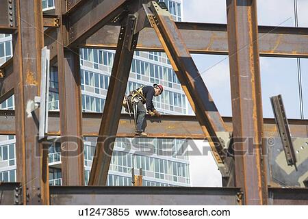 Stock Photography - USA, New York, Long Island, New York City, Male worker on construction site. Fotosearch
