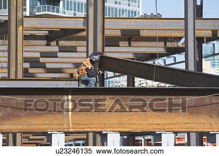Stock Photography - USA, New York, Long Island, New York City, Male worker on construction site. Fotosearch