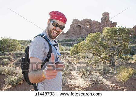 USA, Utah, Moab, Mid adult man posing in remote landscape View Large Photo Image Stock Image - USA, Utah, Moab, Mid adult man posing in remote landscape . Fotosearch