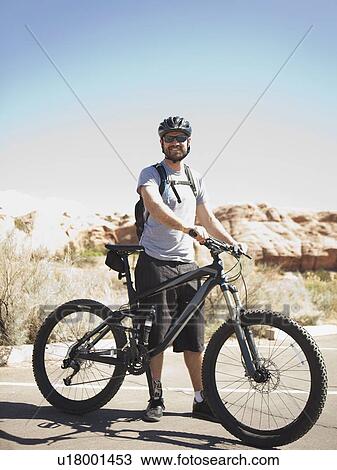 USA, Utah, Moab, Mid adult man posing with mountain bicycle in remote scenery View Large Photo Image Stock Image - USA, Utah, Moab, Mid adult man posing with mountain bicycle in remote scenery. Fotosearch