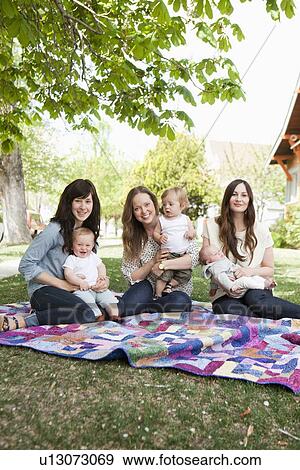 USA, Utah, Salt Lake City, Three young mothers with two baby boys (6-11 months) and toddler boy (2-3) sitting in park View Large Photo Image Stock Photo - USA, Utah, Salt Lake City, Three young mothers with two baby boys (6-11 months) and toddler boy (2-3) sitting in park. Fotosearch
