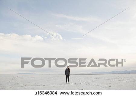 Picture - USA, Utah, Salt Lake City, Young woman standing on desert. Fotosearch