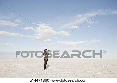 Stock Image - USA, Utah, Salt Lake City, Young woman taking photos. Fotosearch