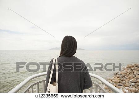 USA, Utah, Salt Lake City, Young woman looking at view View Large Photo Image Stock Photo - USA, Utah, Salt Lake City, Young woman looking at view. Fotosearch
