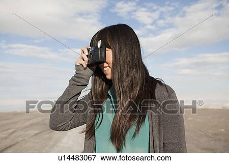 USA, Utah, Salt Lake City, Young woman taking photos View Large Photo Image Stock Photo - USA, Utah, Salt Lake City, Young woman taking photos. Fotosearch