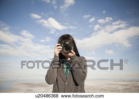 USA, Utah, Salt Lake City, Young woman taking photos View Large Photo Image Stock Photo - USA, Utah, Salt Lake City, Young woman taking photos. Fotosearch
