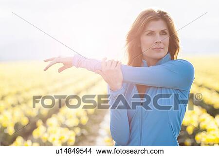 Picture - USA, Washington, Skagit Valley, Portrait of woman in blue tracksuit. Fotosearch