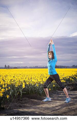 Stock Photograph - USA, Washington, Skagit Valley, Woman exercising in rural area. Fotosearch