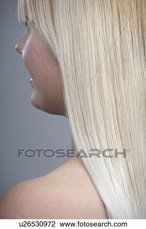Stock Image - View of woman with blonde hair, studio shot. Fotosearch