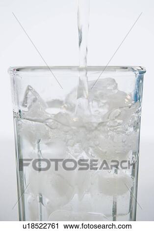 Water being poured into glass with ice cubes View Large Photo Image Stock Image - Water being poured into glass with ice cubes. Fotosearch