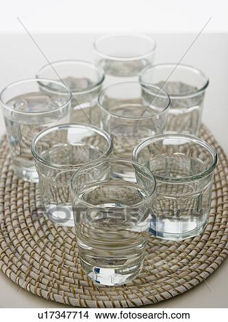 Picture - Water in glasses on place mat. Fotosearch