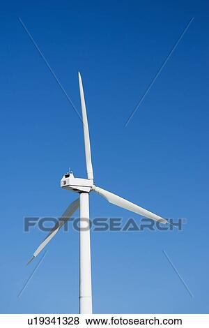 Wind turbine against blue sky View Large Photo Image Stock Photo - Wind turbine against blue sky. Fotosearch