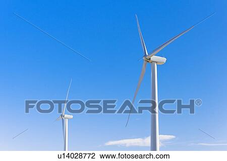 Wind turbines against blue sky View Large Photo Image Stock Image - Wind turbines against blue sky. Fotosearch