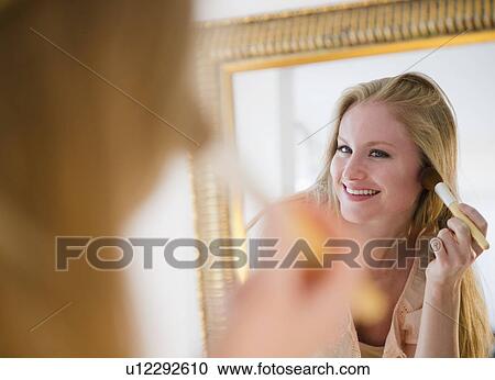 Stock Image - Woman applying blush. Fotosearch