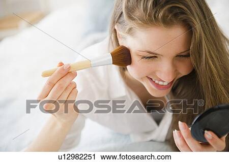 Woman applying make-up View Large Photo Image Stock Image - Woman applying make-up. Fotosearch