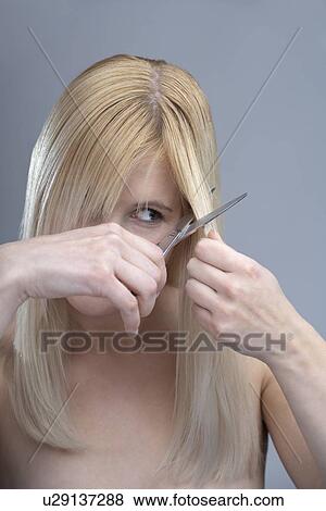 Woman cutting bangs, studio shot View Large Photo Image Stock Photo - Woman cutting bangs, studio shot. Fotosearch