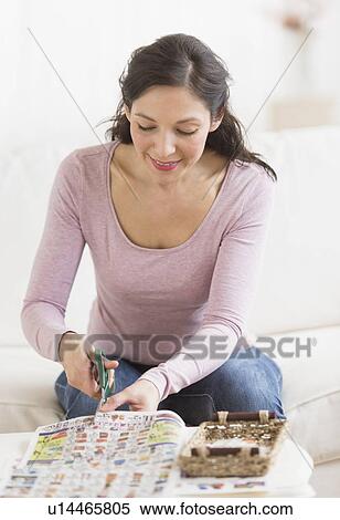 Woman cutting out coupons View Large Photo Image Stock Photography - Woman cutting out coupons. Fotosearch