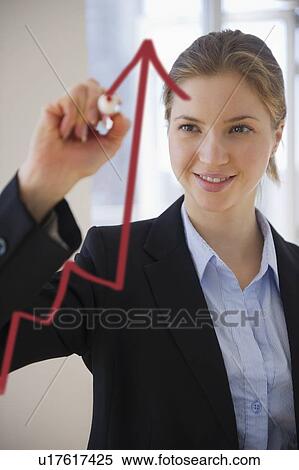 Stock Photography - Woman drawing graph on glass . Fotosearch