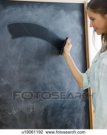 Woman erasing blackboard View Large Photo Image Stock Image - Woman erasing blackboard. Fotosearch