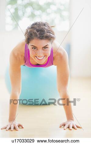 Woman exercising on fitness ball View Large Photo Image Stock Photo - Woman exercising on fitness ball. Fotosearch