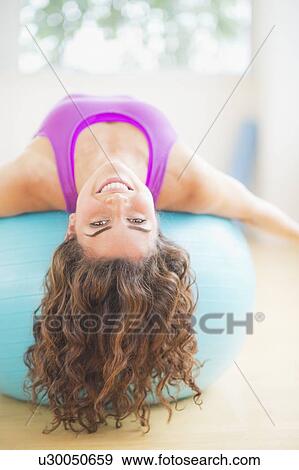 Woman exercising on fitness ball View Large Photo Image Stock Photo - Woman exercising on fitness ball. Fotosearch