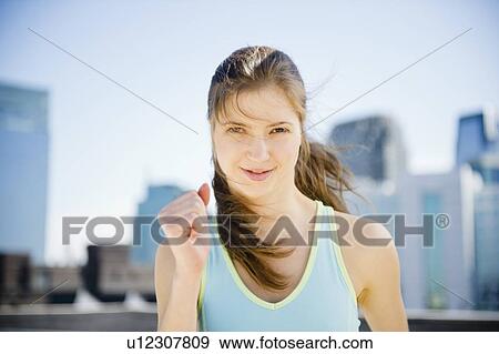 Stock Photo - Woman jogging in city. Fotosearch