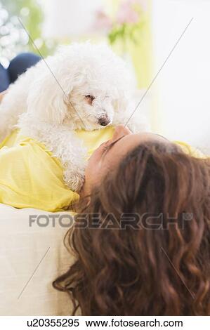 Woman lying on bed with her dog View Large Photo Image Stock Photography - Woman lying on bed with her dog. Fotosearch