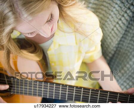 Woman playing guitar View Large Photo Image Stock Photo - Woman playing guitar. Fotosearch